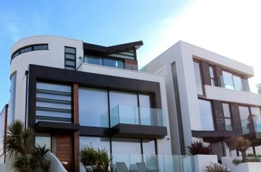 Contemporary luxury home with glass balconies in Poole, UK, showcasing modern architectural design.